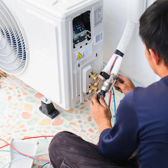 Technician repairing AC unit