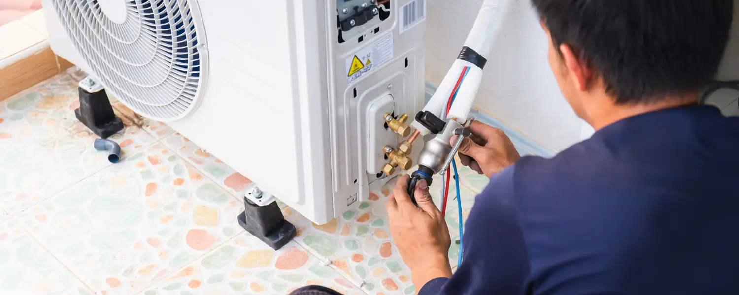 Technician repairing AC unit