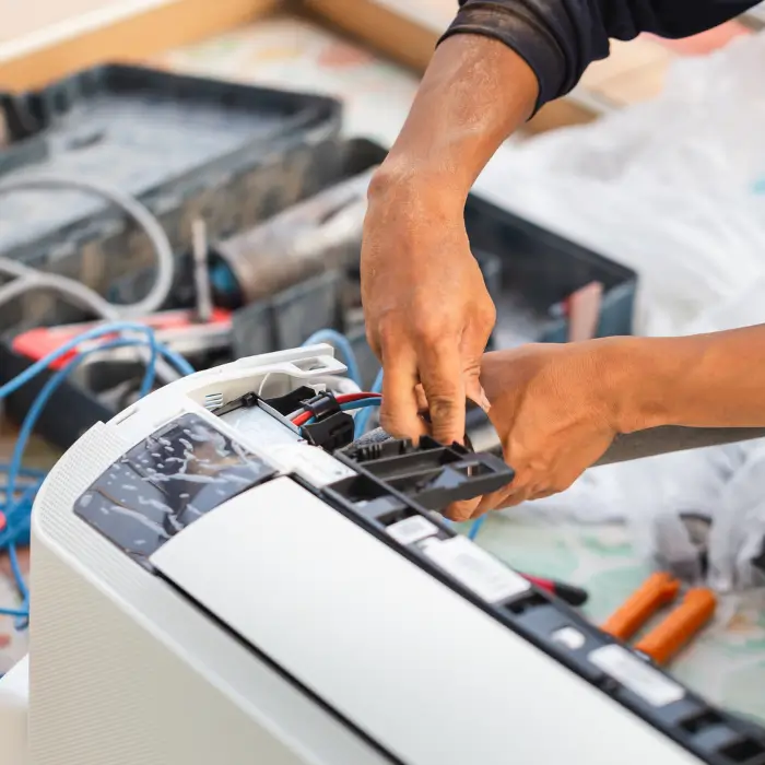 Technician repairing air conditioner unit